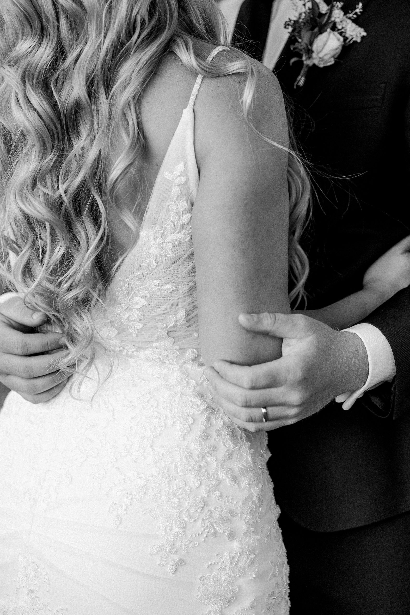 Close up of bride and groom embracing on their wedding day