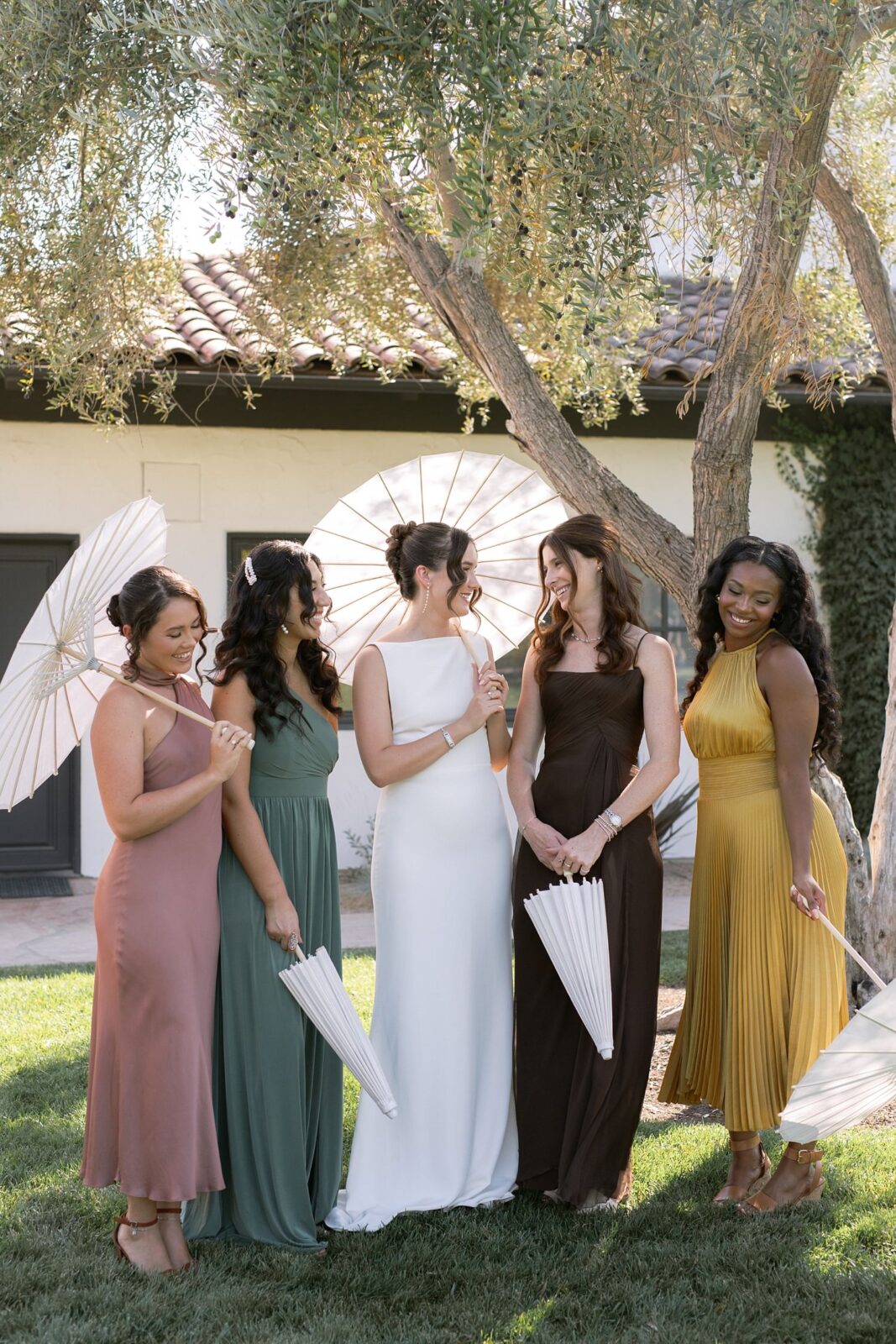 Bridesmaids in different color maxi dresses