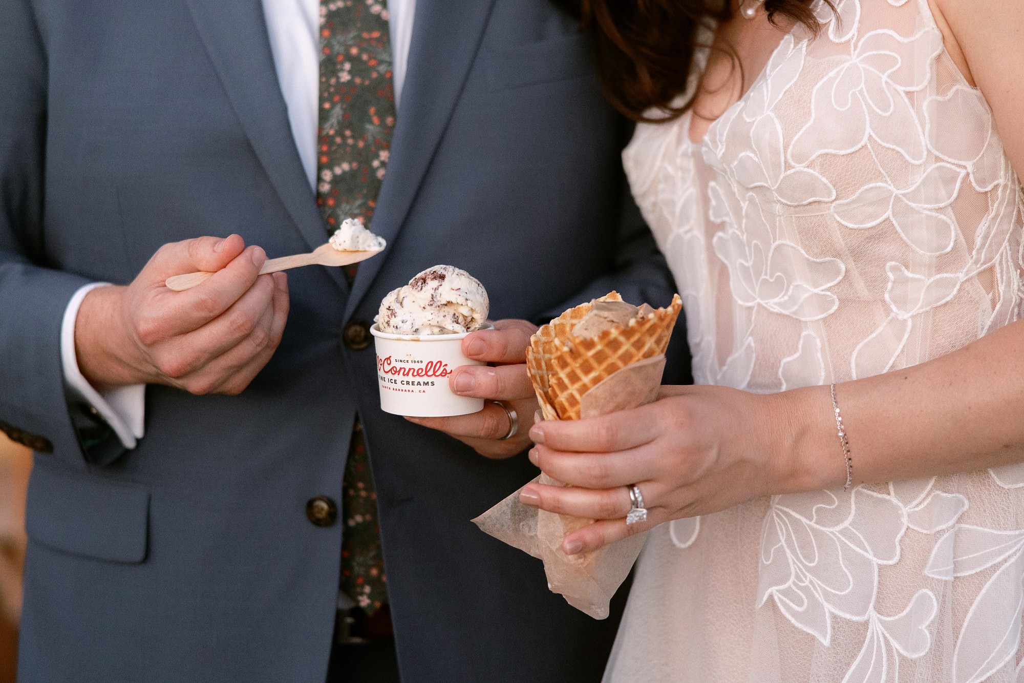 Bride and groom holding ice cream