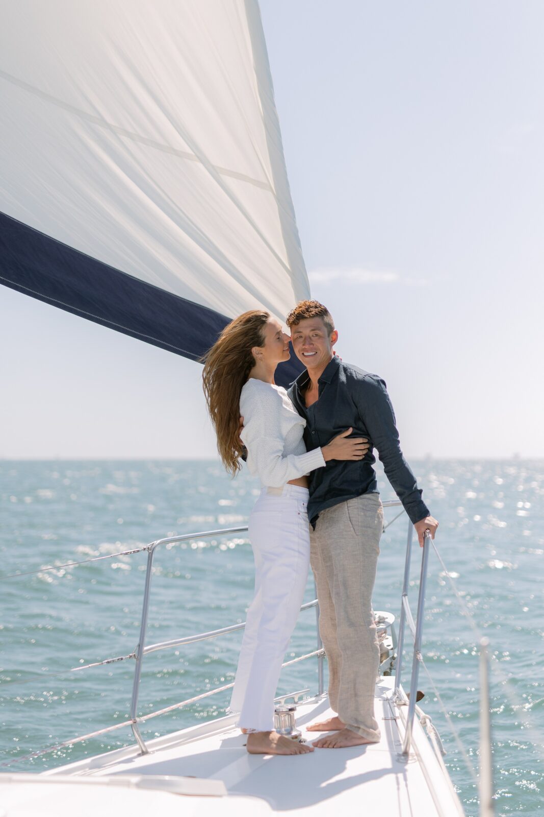 Windy sailboat engagement photos