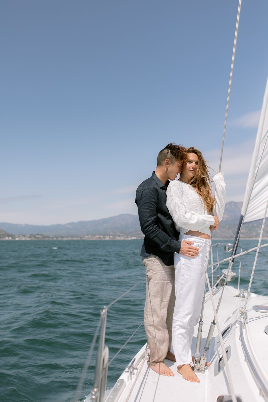 Windy sailboat engagement photos