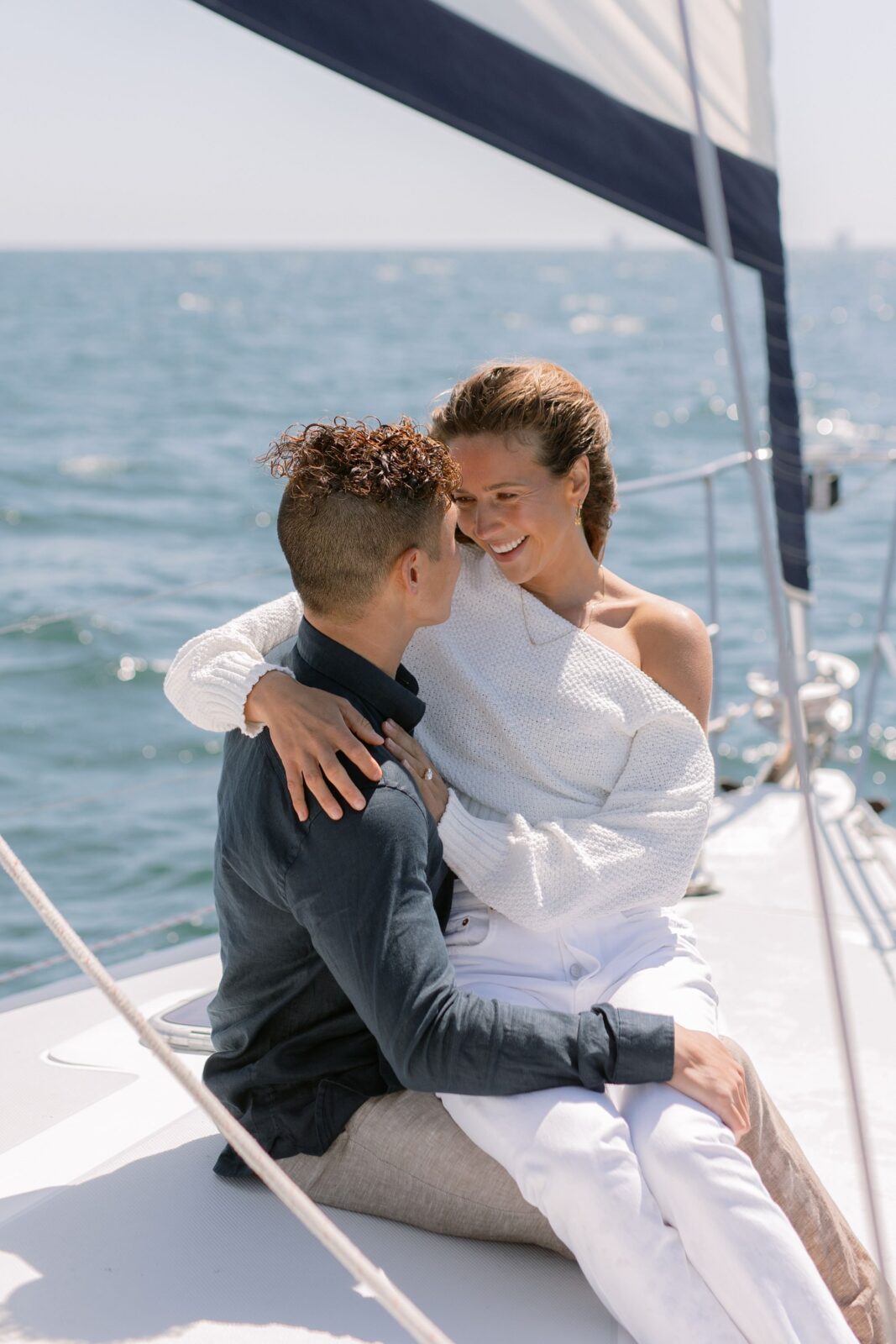 Windy sailboat engagement photos